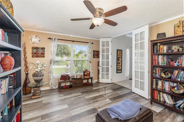 16012 Lanesboro Ct, Clermont, FL 34711 - living area with french doors, a textured ceiling, ceiling fan, wood finished floors, and ornamental molding