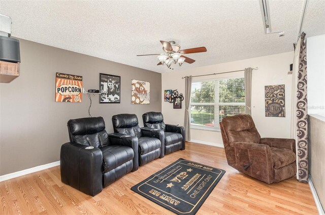 16012 Lanesboro Ct, Clermont, FL 34711 - cinema featuring wood finished floors, a textured ceiling, a ceiling fan, and baseboards