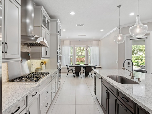 1265 Estancia Woods Loop, Windermere, FL 34786 - kitchen featuring wall chimney range hood, appliances with stainless steel finishes, light tile patterned flooring, pendant lighting, and light stone countertops