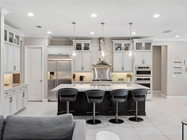 1265 Estancia Woods Loop, Windermere, FL 34786 - kitchen featuring wall chimney exhaust hood, appliances with stainless steel finishes, ornamental molding, decorative backsplash, and recessed lighting