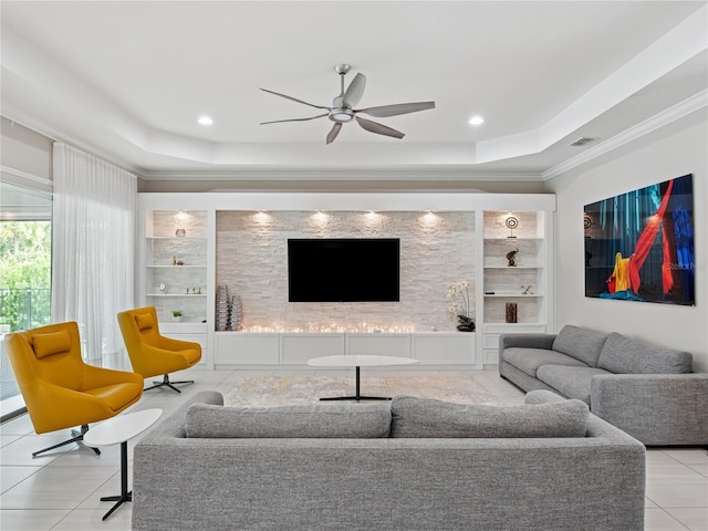 1265 Estancia Woods Loop, Windermere, FL 34786 - living room with a raised ceiling, built in shelves, a ceiling fan, crown molding, and tile patterned floors