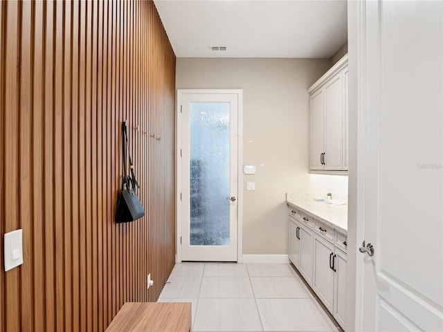 1265 Estancia Woods Loop, Windermere, FL 34786 - laundry area featuring light tile patterned floors and baseboards