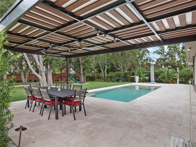 1265 Estancia Woods Loop, Windermere, FL 34786 - view of swimming pool with a patio, outdoor dining area, a fenced backyard, and a playground