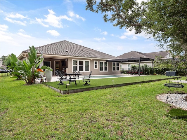 1265 Estancia Woods Loop, Windermere, FL 34786 - rear view of house featuring a yard, a patio area, and a tiled roof