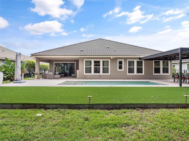 1265 Estancia Woods Loop, Windermere, FL 34786 - back of property with an outdoor hangout area, a patio area, stucco siding, and a yard