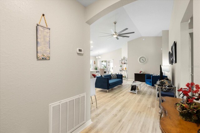 9020 SE 42nd Ct, Ocala, FL 34480 - living room featuring a ceiling fan, vaulted ceiling, arched walkways, and light wood-type flooring