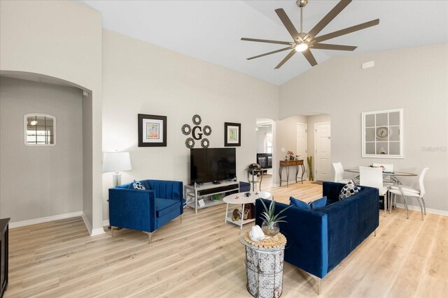9020 SE 42nd Ct, Ocala, FL 34480 - living area with arched walkways, a ceiling fan, light wood finished floors, and high vaulted ceiling