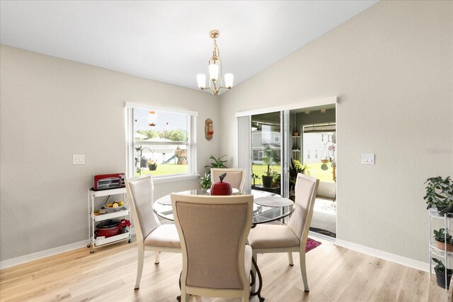 9020 SE 42nd Ct, Ocala, FL 34480 - dining space with a chandelier, light wood-style floors, and lofted ceiling
