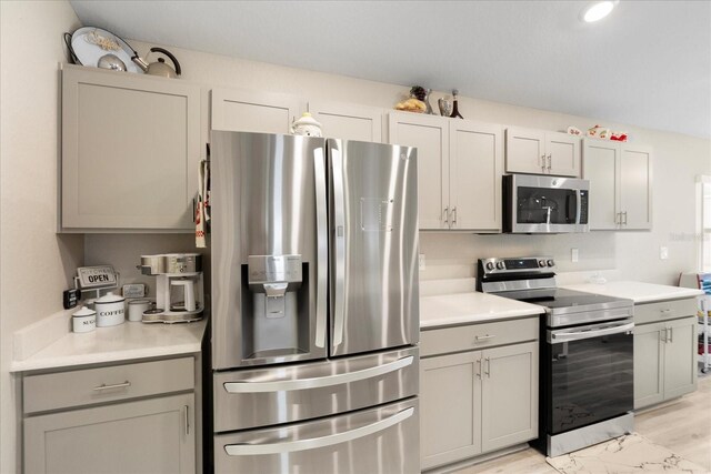 9020 SE 42nd Ct, Ocala, FL 34480 - kitchen with stainless steel appliances, gray cabinets, and light countertops