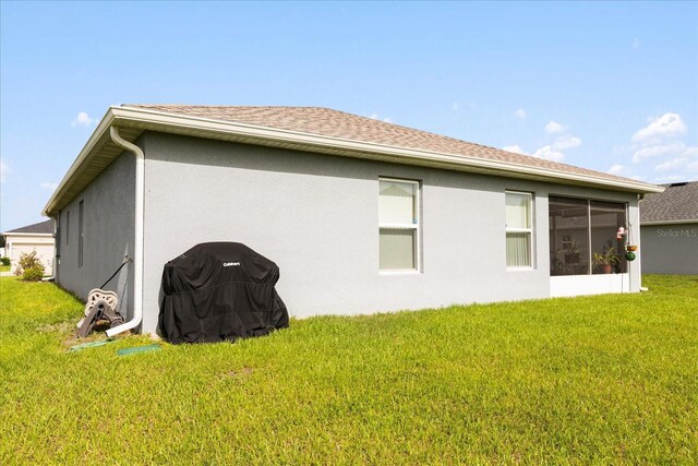 9020 SE 42nd Ct, Ocala, FL 34480 - view of side of home featuring a lawn, stucco siding, and a shingled roof