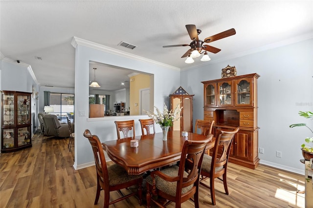 3562 Foxchase Dr, Clermont, FL 34711 - dining room featuring ceiling fan, light wood finished floors, and ornamental molding
