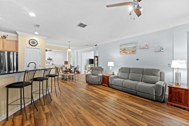 3562 Foxchase Dr, Clermont, FL 34711 - living room featuring wood finished floors, crown molding, ceiling fan, and recessed lighting