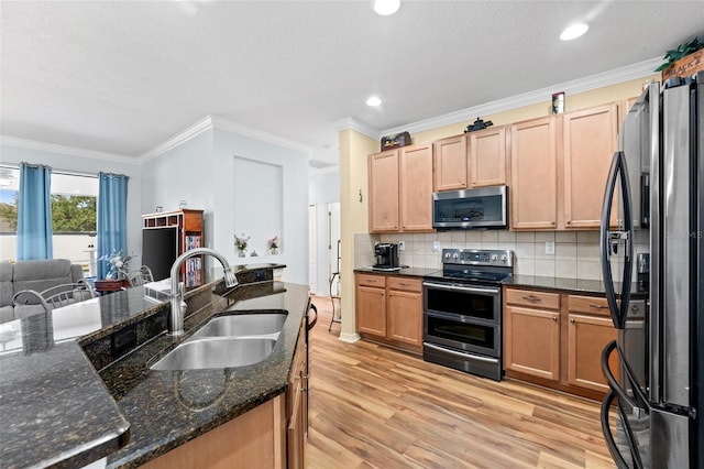 3562 Foxchase Dr, Clermont, FL 34711 - kitchen with stainless steel appliances, light wood-style floors, decorative backsplash, crown molding, and dark stone counters