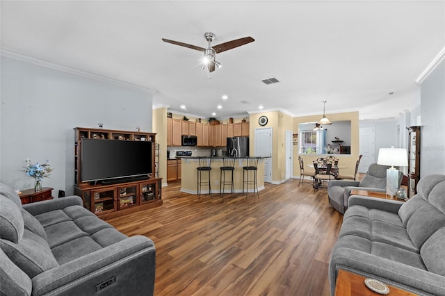 3562 Foxchase Dr, Clermont, FL 34711 - living area with crown molding, wood finished floors, ceiling fan, and recessed lighting