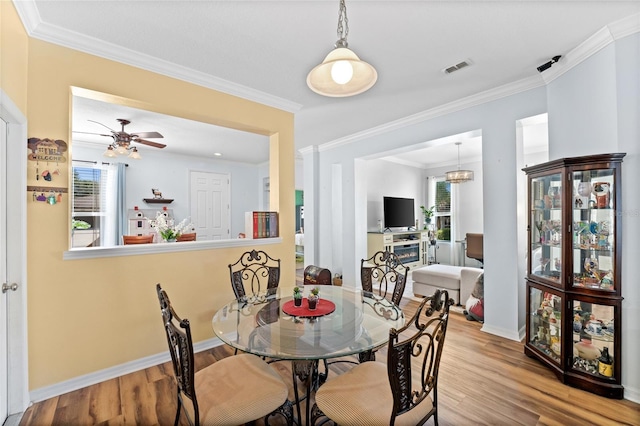 3562 Foxchase Dr, Clermont, FL 34711 - dining space featuring wood finished floors, ornamental molding, and a ceiling fan