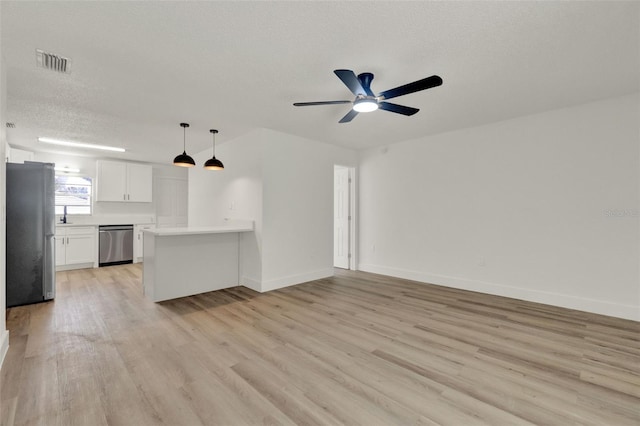 324 James Pl, Saint Cloud, FL 34769 - unfurnished living room featuring light wood finished floors, ceiling fan, baseboards, a textured ceiling, and a sink