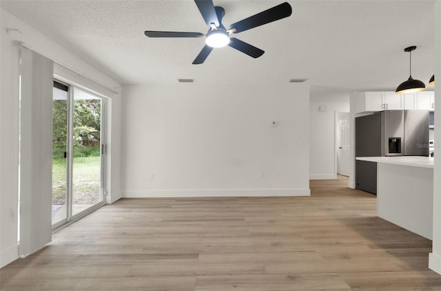 324 James Pl, Saint Cloud, FL 34769 - unfurnished living room with light wood-type flooring, a ceiling fan, and baseboards