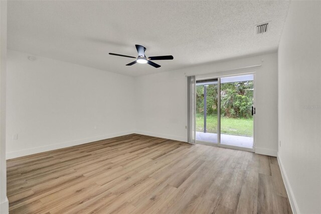 324 James Pl, Saint Cloud, FL 34769 - empty room featuring light wood-type flooring, baseboards, a ceiling fan, and a textured ceiling