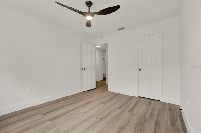 324 James Pl, Saint Cloud, FL 34769 - unfurnished bedroom with light wood-style floors, baseboards, and a ceiling fan