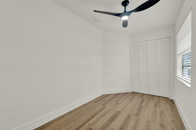 324 James Pl, Saint Cloud, FL 34769 - unfurnished bedroom featuring light wood-style flooring, baseboards, a closet, and ceiling fan