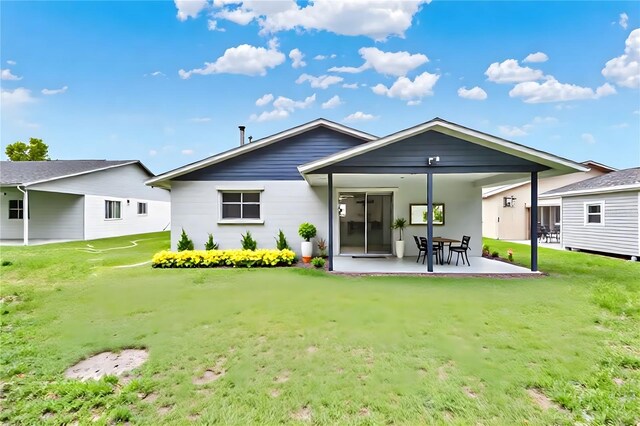324 James Pl, Saint Cloud, FL 34769 - rear view of property with a patio and a lawn