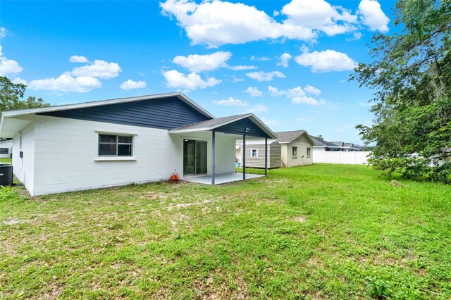 324 James Pl, Saint Cloud, FL 34769 - back of property featuring a patio area and central AC unit