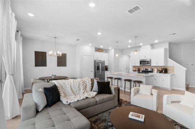 1932 Terrapin Rd, Ocoee, FL 34761 - living room featuring a chandelier and recessed lighting