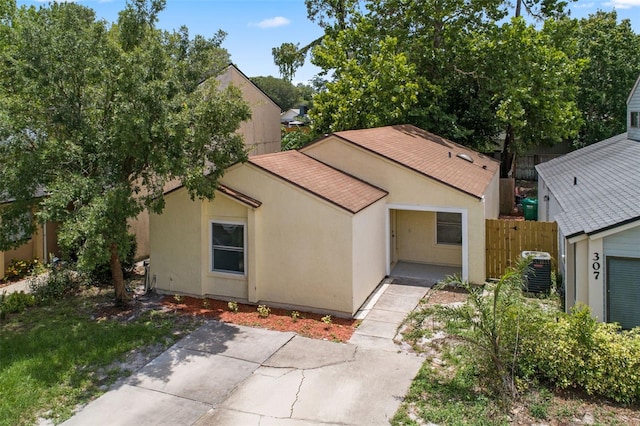 309 Kirkcaldy Dr, Winter Springs, FL 32708 - view of front of property with a shingled roof, a patio area, central air condition unit, and stucco siding