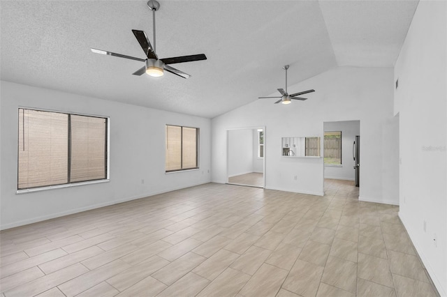 309 Kirkcaldy Dr, Winter Springs, FL 32708 - unfurnished living room featuring ceiling fan, plenty of natural light, high vaulted ceiling, a textured ceiling, and baseboards