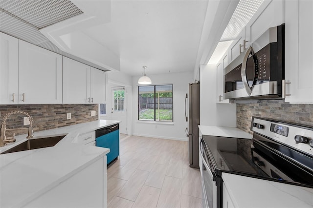 309 Kirkcaldy Dr, Winter Springs, FL 32708 - kitchen with appliances with stainless steel finishes, a sink, tasteful backsplash, and white cabinets