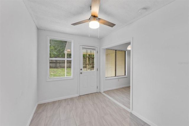 309 Kirkcaldy Dr, Winter Springs, FL 32708 - entryway with baseboards, a ceiling fan, and a textured ceiling