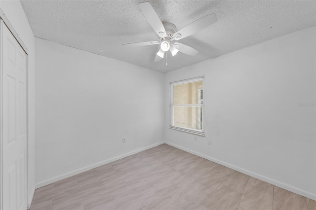 309 Kirkcaldy Dr, Winter Springs, FL 32708 - unfurnished bedroom with a closet, a textured ceiling, a ceiling fan, and baseboards