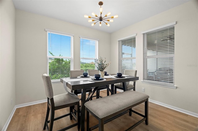 7163 Talamore Dr, Wesley Chapel, FL 33545 - dining area featuring a chandelier, baseboards, and light wood finished floors