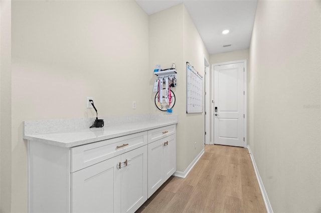 7163 Talamore Dr, Wesley Chapel, FL 33545 - hallway featuring light wood-style floors and baseboards