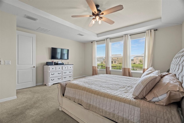7163 Talamore Dr, Wesley Chapel, FL 33545 - bedroom with light colored carpet, baseboards, ceiling fan, and a raised ceiling