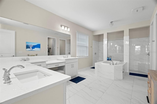 7163 Talamore Dr, Wesley Chapel, FL 33545 - full bathroom with marble finish floors, two vanities, a garden tub, and a walk in shower