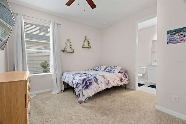 7163 Talamore Dr, Wesley Chapel, FL 33545 - carpeted bedroom featuring multiple windows, baseboards, ensuite bathroom, and ceiling fan