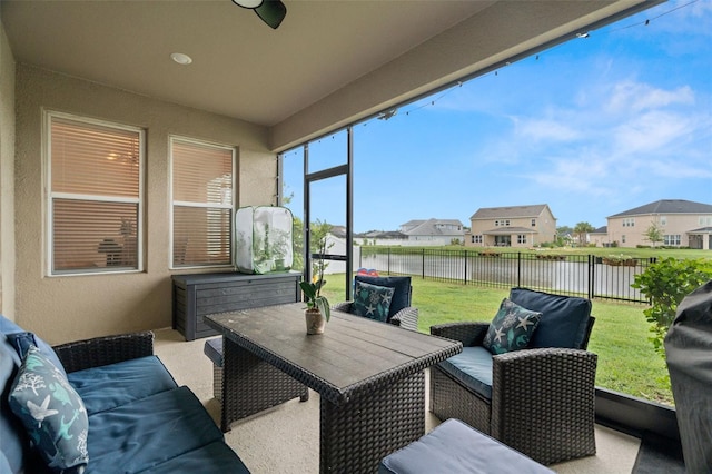 7163 Talamore Dr, Wesley Chapel, FL 33545 - sunroom featuring a water view, a residential view, and an outdoor living space