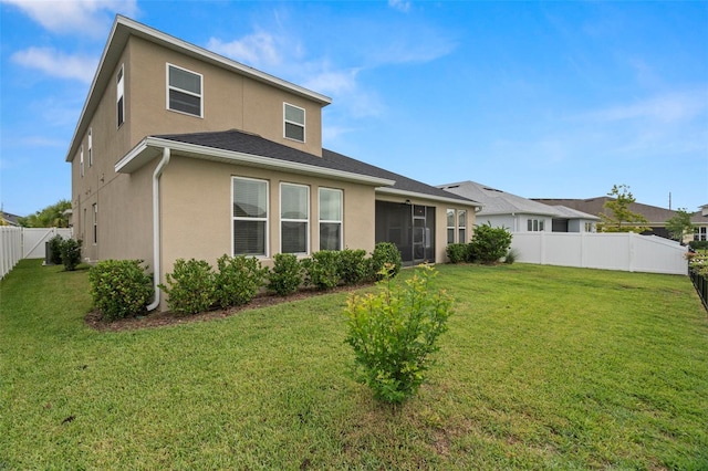 7163 Talamore Dr, Wesley Chapel, FL 33545 - rear view of house featuring stucco siding and a sunroom