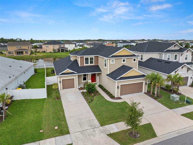 7163 Talamore Dr, Wesley Chapel, FL 33545 - traditional home featuring a residential view, concrete driveway, roof with shingles, and stucco siding