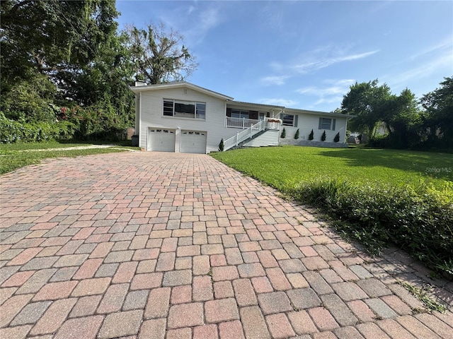 3702 Mirror Lake Dr, Apopka, FL 32703 - ranch-style home with decorative driveway, a garage, and a front lawn