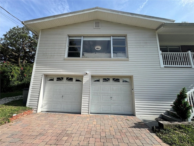 3702 Mirror Lake Dr, Apopka, FL 32703 - view of side of property with a garage, decorative driveway, and a balcony