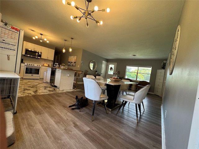 3702 Mirror Lake Dr, Apopka, FL 32703 - dining area featuring a chandelier and wood finished floors