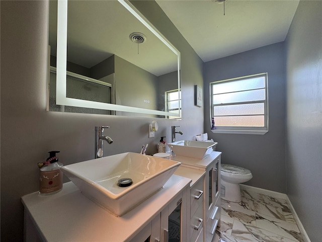 3702 Mirror Lake Dr, Apopka, FL 32703 - full bathroom with double vanity, marble look tiles, toilet, a stall shower, and baseboards