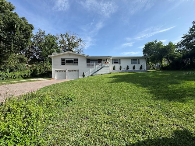 3702 Mirror Lake Dr, Apopka, FL 32703 - ranch-style house with a garage, decorative driveway, a front lawn, and stairway