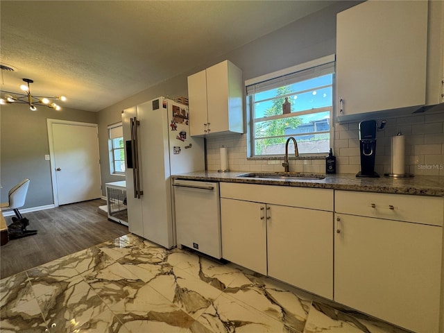 3702 Mirror Lake Dr, Apopka, FL 32703 - kitchen with white appliances, a sink, white cabinets, tasteful backsplash, and baseboards