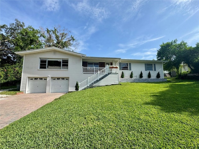 3702 Mirror Lake Dr, Apopka, FL 32703 - single story home with decorative driveway, an attached garage, a front lawn, stairs, and covered porch