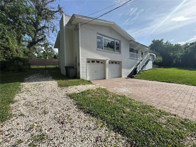 3702 Mirror Lake Dr, Apopka, FL 32703 - view of property exterior with stairway, decorative driveway, a lawn, a garage, and a porch