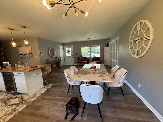 3702 Mirror Lake Dr, Apopka, FL 32703 - dining room featuring dark wood-type flooring, wine cooler, a textured ceiling, baseboards, and a chandelier