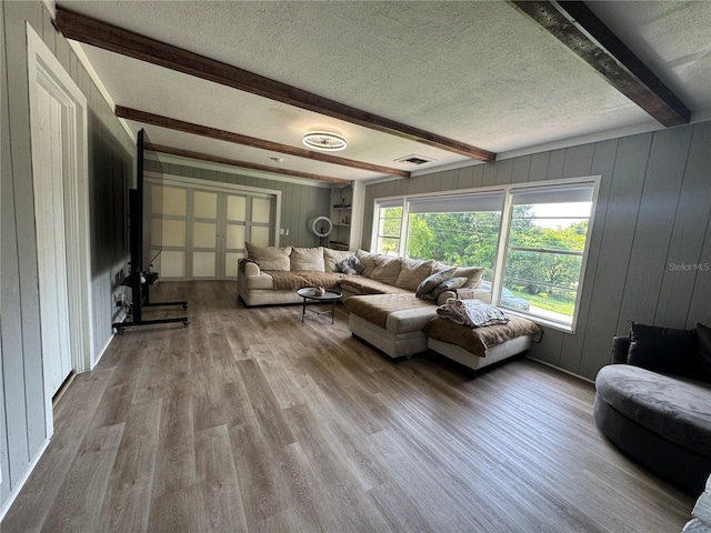 3702 Mirror Lake Dr, Apopka, FL 32703 - living room with beamed ceiling, wood finished floors, a textured ceiling, and wooden walls